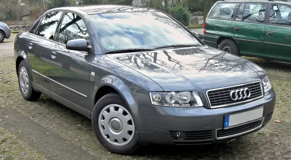 Szary sedan Audi A4 B6 zaparkowany na zewnątrz.