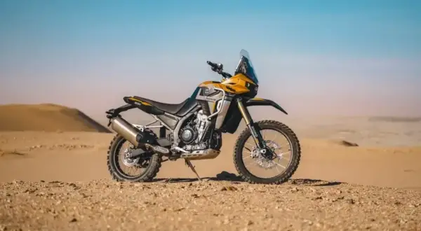 Żółto-czarny motocykl Kove 800x Rally gotowy na pustynne wyzwania.