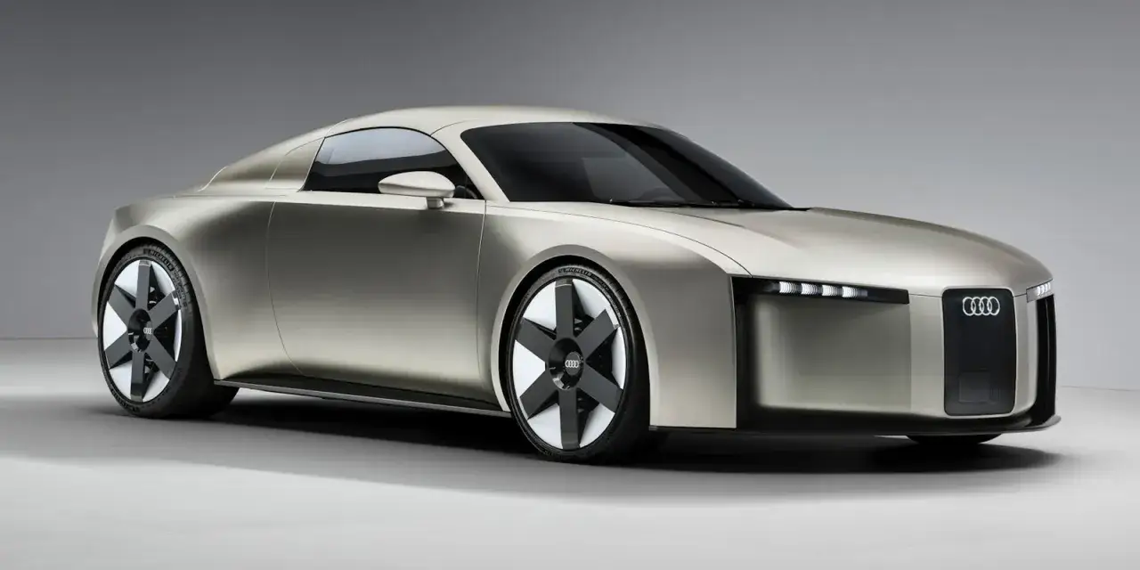 Futurystyczne, srebrne najnowsze Audi z ostrymi liniami i unikalnymi felgami, prezentujące innowacyjny design.