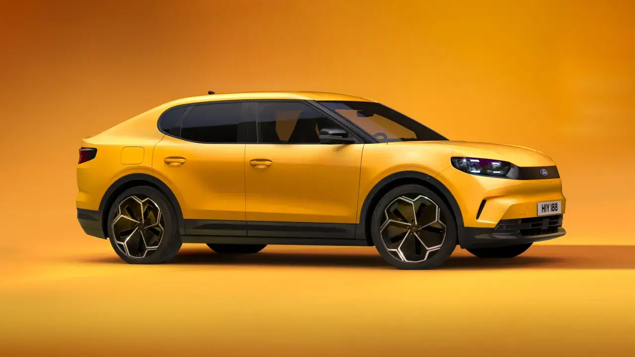 Żółty Ford Capri 2025, sportowy SUV z futurystycznym designem, prezentuje się na pomarańczowym tle.