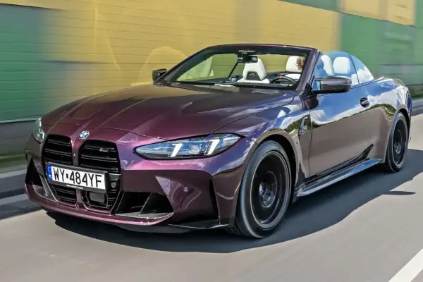 Fioletowe BMW M4 Cabrio na drodze. Zastanawiasz się, ile kosztuje BMW M4? Ten model to marzenie wielu kierowców.